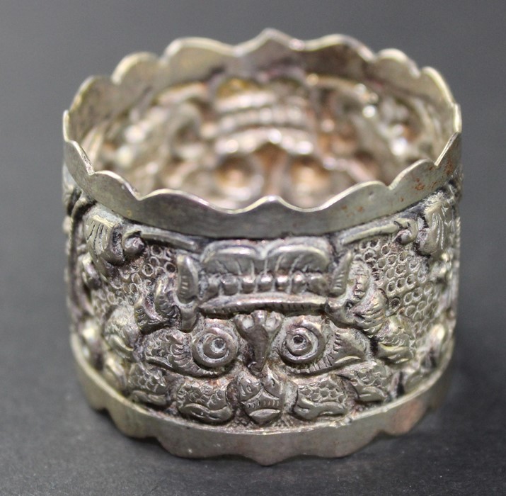 A set of twelve Cambodian silver place name/menu holders, of square form, repousse decorated flowers - Image 4 of 4