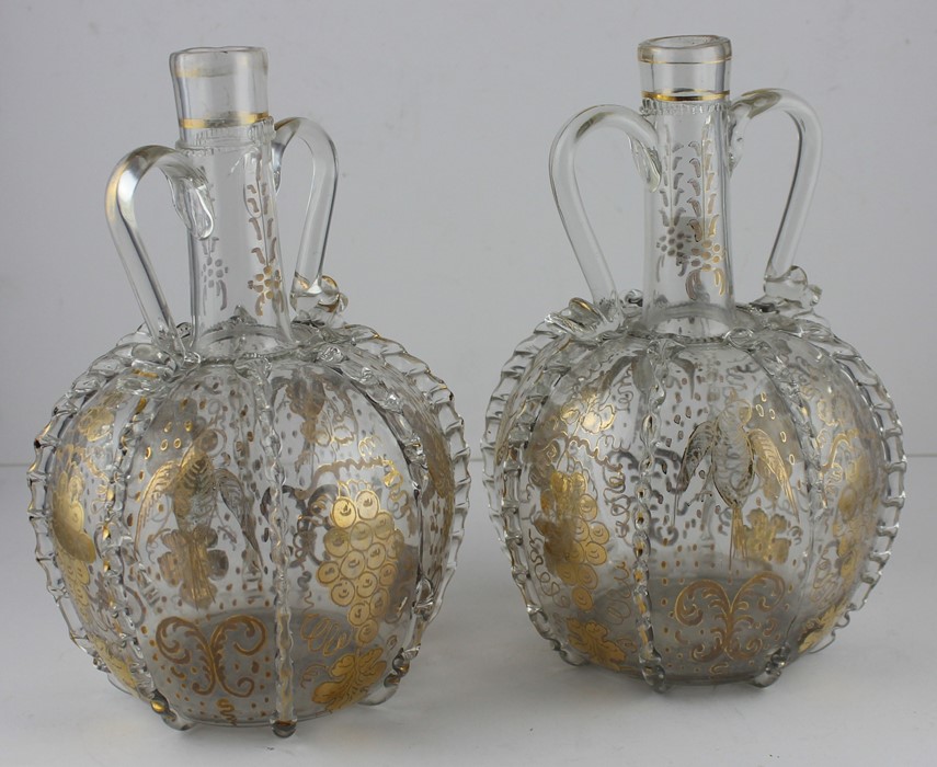 A pair of late 19th cent Continental glass carafes, gilded with birds and floral decoration