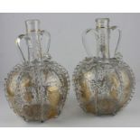 A pair of late 19th cent Continental glass carafes, gilded with birds and floral decoration