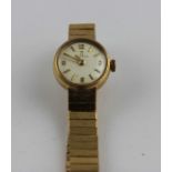 A 9ct. gold Omega ladies cocktail watch, c.1960's, manual movement, circular champagne dial with