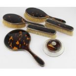 A matched six piece tortoiseshell and silver mounted dressing set, comprising a pair of hair