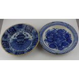 Two 18th century  tin glazed Delft plates, both painted in blue with flowers and leaves, both 26
