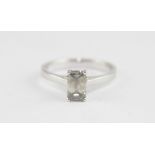 An 18ct. white gold and solitaire diamond ring, four claw set emerald cut diamond (approx. 1.13