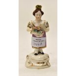 A porcelain figure of a girl holding flowers