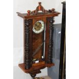 A late 19th Century mahogany cased wall clock, with keys and pendulum.