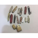 A collection of 14 Penknives and Fruit knives plus a brass bodied "Zippo" Cigarette Lighter marked