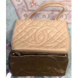 A large leather tote in cream by an Arabic company with a Prada faux badge,