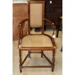 An early 20th Century mahogany open armchair, padded back, padded seat,