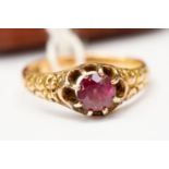 An Victorian 18ct gold ring set with purple paste, scroll work to mount, size N,