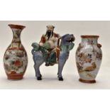 A Japanese figure of Hatei riding a dog of foe and two Kutani vases (3)