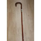 A gentlemans walking cane with brass collar