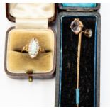 An Edwardian opal and 9ct gold ring, the elongated opal with a border of white stones, size N,