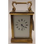 Late 19th Century brass carriage clock with white enamelled dial, black Roman numerals,