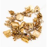 A 9ct gold charm bracelet with various 9ct gold and unmarked yellow metal charms including an 1866