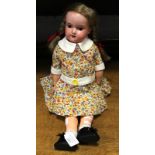 A German bisque composition doll and the rear of the head stamp Armand Marseille 390 AOM