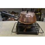 A mid century copper fondue on stand with burner