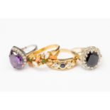 3 yellow metal stone set dress rings and a white gold pear shaped amethyst and diamond cluster ring,