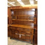 An Old Charm oak dresser and rack, the rack with two lead glazed doors and two plate shelves,