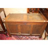 An early 18th Century joined oak chest, panelled top, front and sides, raised on stile feet,