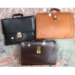 Two leather brief cases and one other