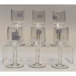 A set of six Victorian cut glass wine glasses with hollow stems,