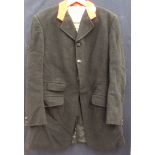 A black wood hunting jacket with a red collar made by Moss Bros with a black and cream check lining