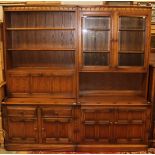 An Ercol elm side unit, the upper section fitted with two glazed doors enclosing shelves,