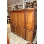 A George III oak linen press, of breakfront form, the cornice with plain dentil moulding,