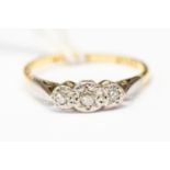 A diamond three stone illusion set ring in 18ct gold, size P, total gross weight approx 2.