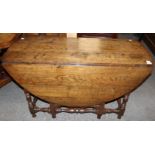 A traditional joined oak gateleg table, plank top,