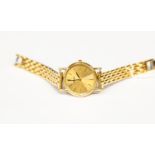 A ladies 9ct gold Seiko watch, round dial, gold tone, case diameter approx 23mm,