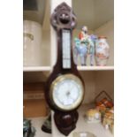 A carved oak cased Edwardian aneroid barometer (English)