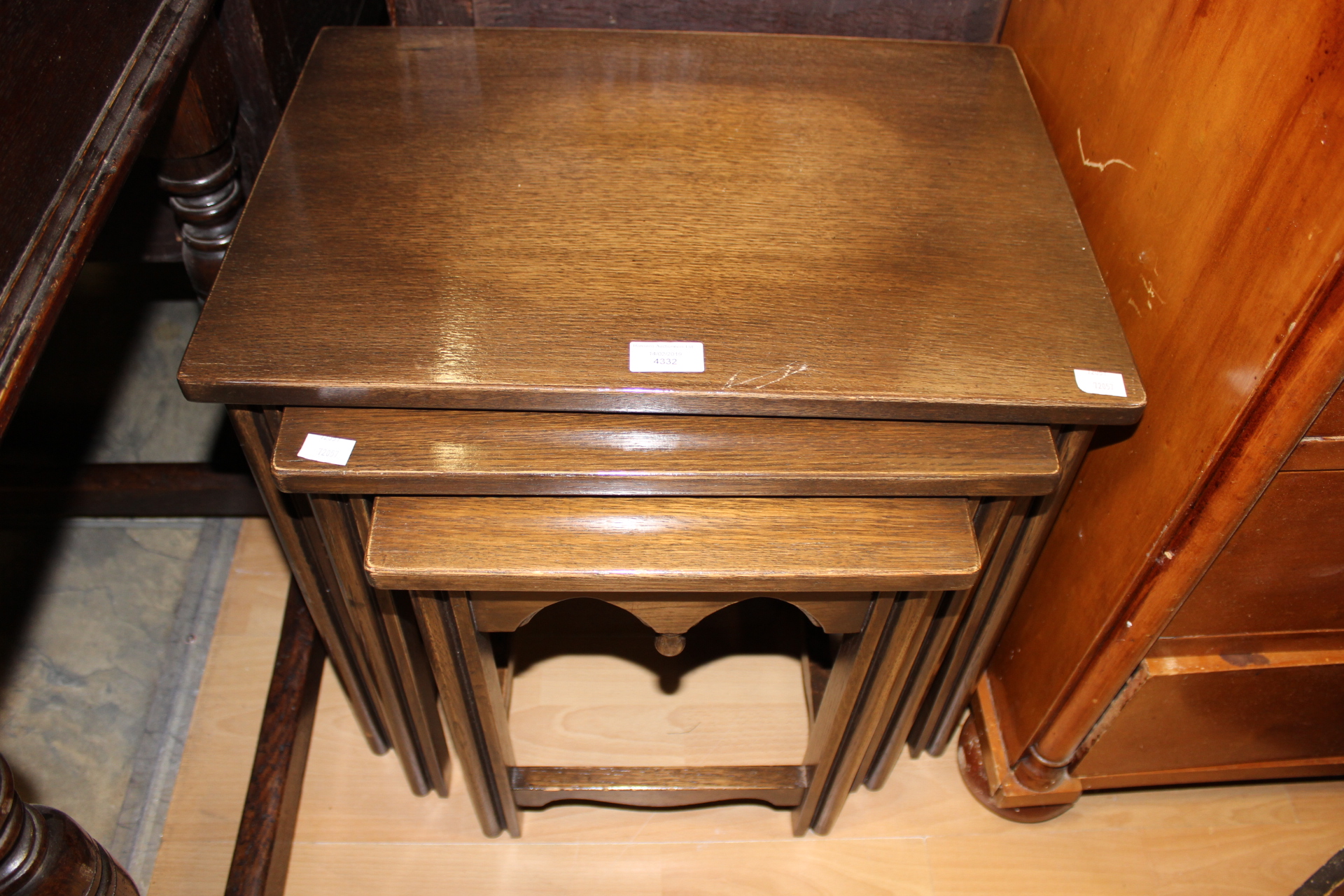 A 20th Century oak nest of three tables,