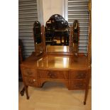 An Edwardian mahogany mirror backed dressing table, having a triple sectioned mirror,