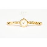 A 9ct gold ladies Rotary watch, round dial, batons, cream enamel dial, approx diameter 15mm,