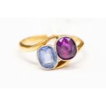 An 18 ct gold ruby and sapphire ring, cross over design with rubover set stones, size K,