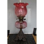 Oil lamp with ruby coloured bowl and shade