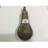Copper and brass blackpowder flask. Shell type design to both side.