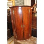 A George III mahogany hanging corner cupboard.