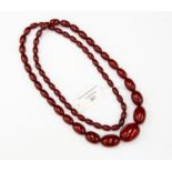 A graduated bead necklace, cherry tone, length approx 22', total gross weight approx 66.