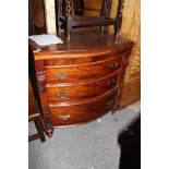 A Victorian mahogany bow fronted chest of drawers fitted with a secret frieze drawer over three