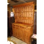 A 20th Century pine kitchen dresser and rack, the rack with two plate shelves, four spice drawers,