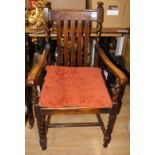 An early 20th Century Carolean style oak open armchair,