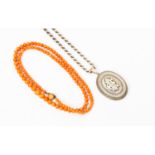 A graduated coral bead necklace;