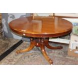 A late Victorian mahogany tilt-top breakfast table, raised on a pedestal base,