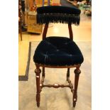 A 19th Century walnut high chair , the seat and back uplholstered in dark blue velvet.