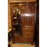 An Edwardian mahogany compactum wardrobe, comprising mirrored door, panelled door,