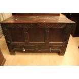 An early 18th Century oak joined mule chest, having a carved front, fitted with two drawers below,