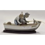 Lladro large figure of man and boy in boat with dog Condition: One oar unattached Bottle missing
