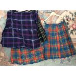 A collection of black/purple Scottish kilts,